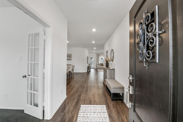 corridor featuring recessed lighting and dark wood-type flooring
