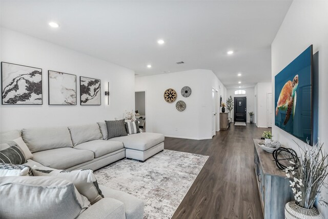 living room featuring recessed lighting, baseboards, and dark wood-style floors