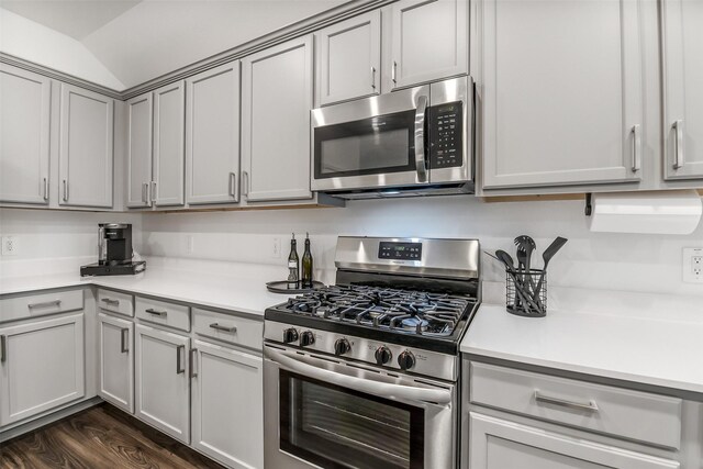 kitchen with light countertops, appliances with stainless steel finishes, dark wood-style floors, and gray cabinetry