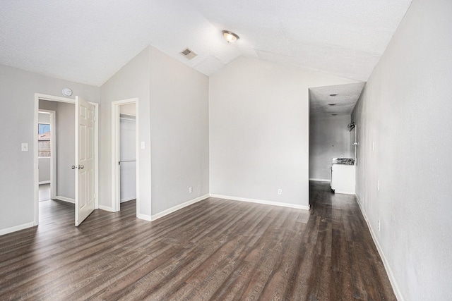 16226 Alden Ridge Dr, Houston, TX 77053 - unfurnished living room with baseboards, vaulted ceiling, dark wood-style floors, and visible vents