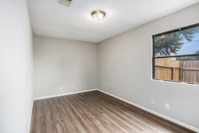 16226 Alden Ridge Dr, Houston, TX 77053 - spare room with visible vents, baseboards, a textured ceiling, and wood finished floors