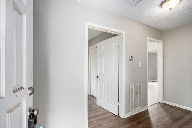 16226 Alden Ridge Dr, Houston, TX 77053 - hallway featuring visible vents, a textured ceiling, baseboards, and wood finished floors
