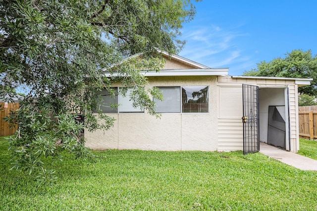 16226 Alden Ridge Dr, Houston, TX 77053 - view of property exterior with a lawn, fence, and stucco siding