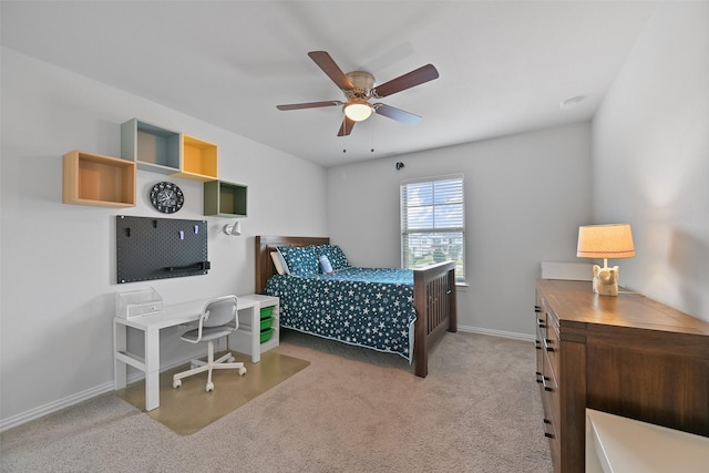 carpeted bedroom with a ceiling fan and baseboards