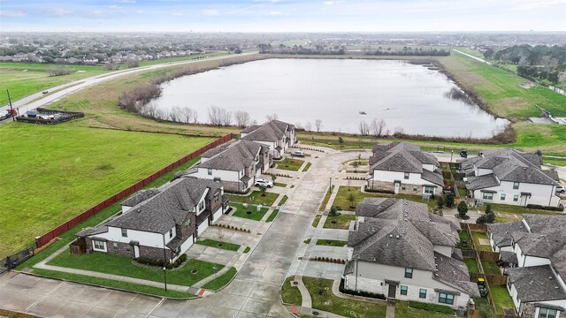 drone / aerial view with a residential view and a water view