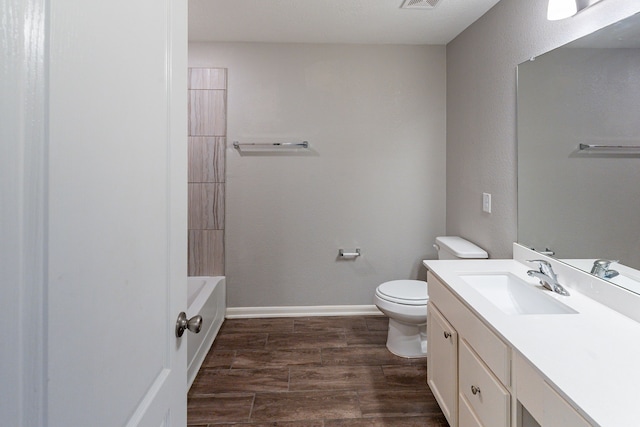bathroom with visible vents, wood finished floors, vanity, baseboards, and toilet