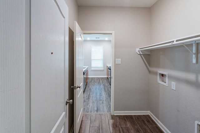clothes washing area with baseboards, laundry area, washer hookup, and dark wood-type flooring