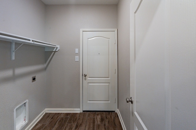 washroom featuring hookup for an electric dryer, laundry area, baseboards, and dark wood-type flooring