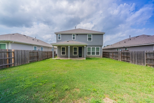 back of house featuring a yard, a patio, and a fenced backyard