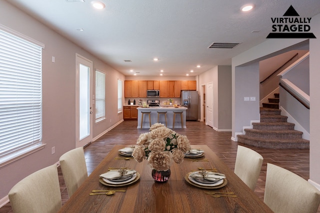 4219 Mossy Banks Ln, Houston, TX 77068 - dining space featuring dark wood-style floors, baseboards, recessed lighting, and stairway