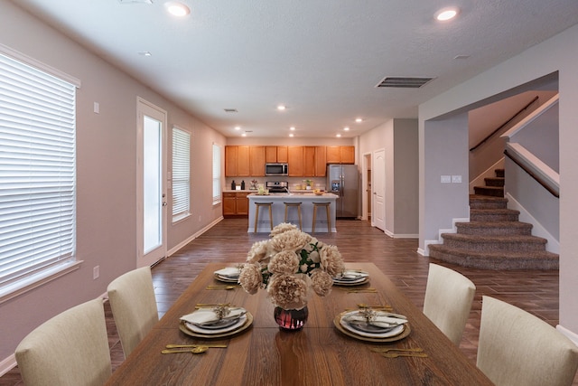 4219 Mossy Banks Ln, Houston, TX 77068 - dining area featuring dark wood-style floors, baseboards, recessed lighting, and stairway