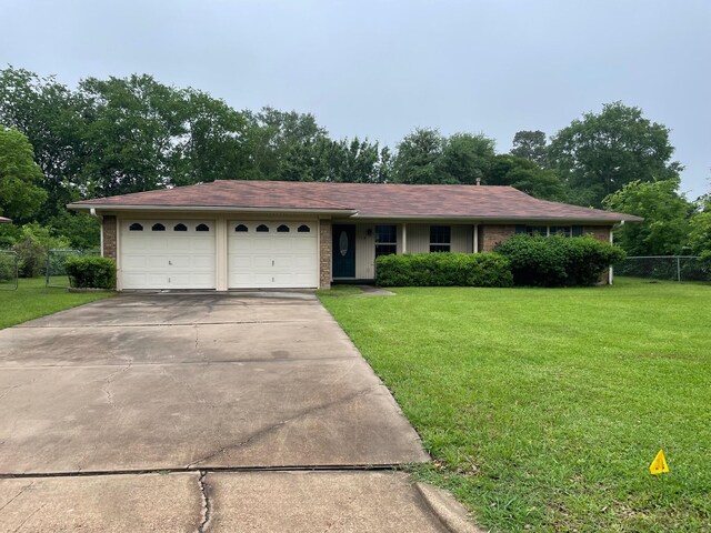 single story home with brick siding, a front yard, and a garage