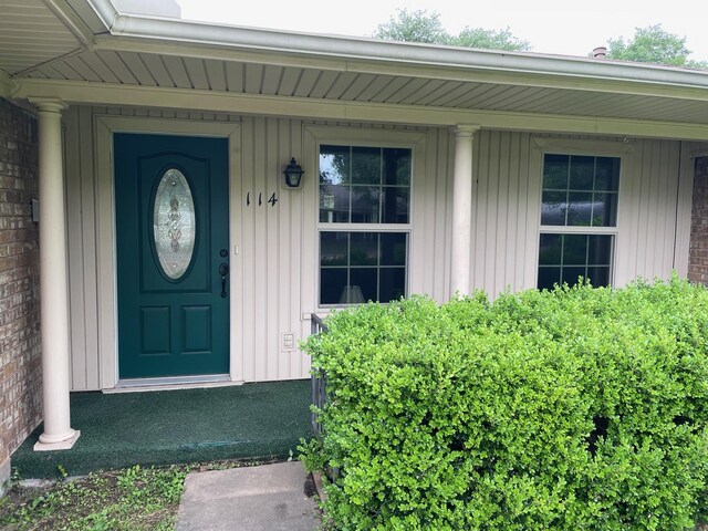 entrance to property featuring a porch and board and batten siding