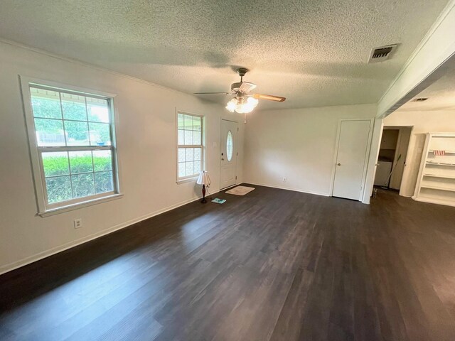 spare room featuring visible vents, baseboards, ceiling fan, dark wood-style floors, and a textured ceiling