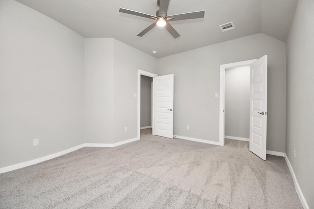 unfurnished bedroom featuring carpet floors, baseboards, visible vents, and ceiling fan
