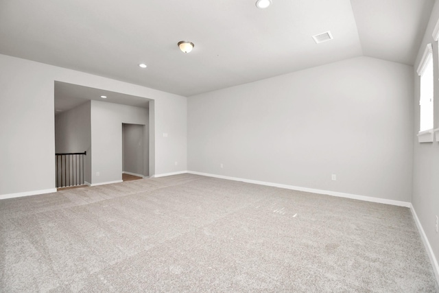 unfurnished room featuring carpet floors, baseboards, vaulted ceiling, and recessed lighting