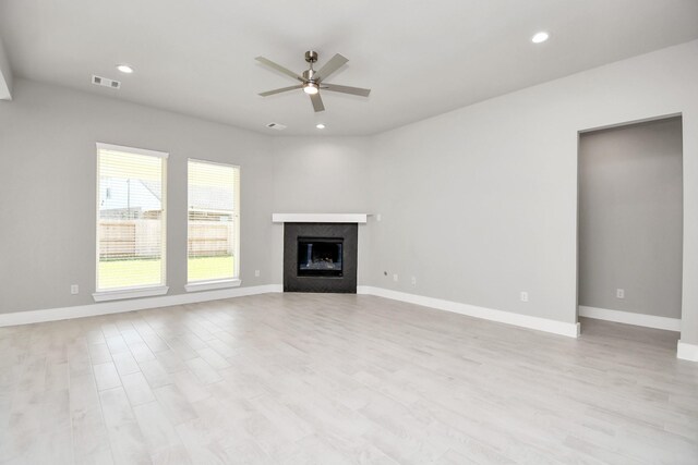 unfurnished living room with light wood-style floors, ceiling fan, recessed lighting, and visible vents