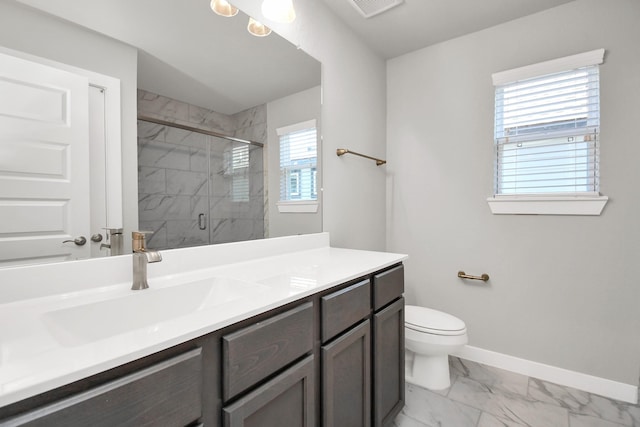 full bath featuring baseboards, vanity, toilet, marble finish floor, and a marble finish shower