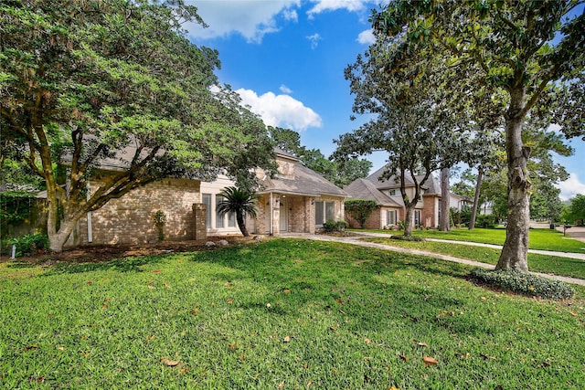 14211 Lakewood Forest Dr, Houston, TX 77070 - view of front of home featuring brick siding, driveway, and a front yard