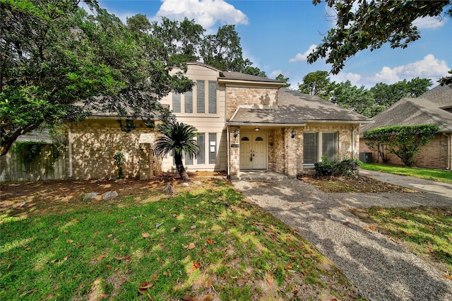 14211 Lakewood Forest Dr, Houston, TX 77070 - view of front of home featuring brick siding, a shingled roof, and a front yard