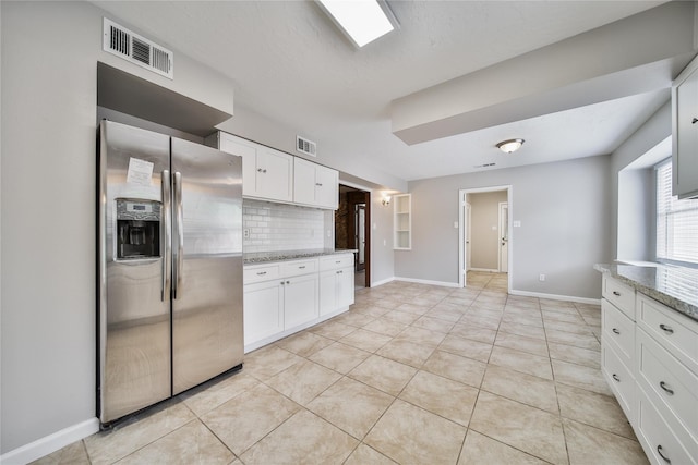 14211 Lakewood Forest Dr, Houston, TX 77070 - kitchen with stainless steel refrigerator with ice dispenser, white cabinets, backsplash, and visible vents