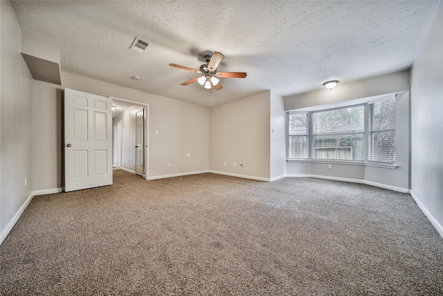 14211 Lakewood Forest Dr, Houston, TX 77070 - carpeted spare room with baseboards, ceiling fan, a textured ceiling, and visible vents