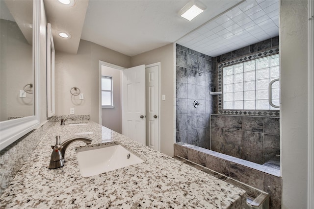 14211 Lakewood Forest Dr, Houston, TX 77070 - full bathroom featuring double vanity, a sink, a walk in shower, and recessed lighting