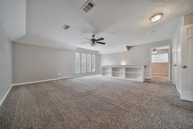 14211 Lakewood Forest Dr, Houston, TX 77070 - carpeted spare room with a healthy amount of sunlight, a ceiling fan, a textured ceiling, and visible vents
