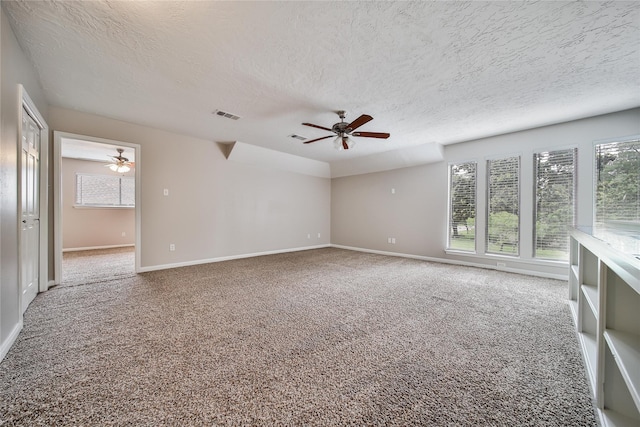 14211 Lakewood Forest Dr, Houston, TX 77070 - unfurnished room with carpet floors, a textured ceiling, a ceiling fan, baseboards, and visible vents