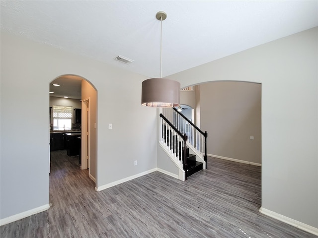3111 Silverstag Trail Ln, Houston, TX 77073 - spare room with arched walkways, baseboards, wood finished floors, and visible vents