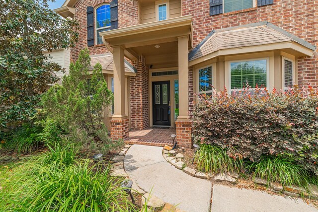 property entrance with brick siding