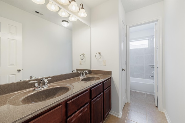 bathroom with tile patterned flooring, a sink, and baseboards