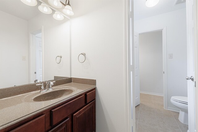 bathroom with vanity, tile patterned floors, toilet, and visible vents
