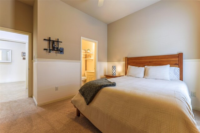 bedroom featuring carpet floors, a ceiling fan, and ensuite bathroom