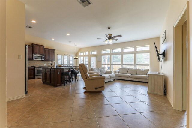 living area featuring ceiling fan, recessed lighting, baseboards, light tile patterned floors, and visible vents