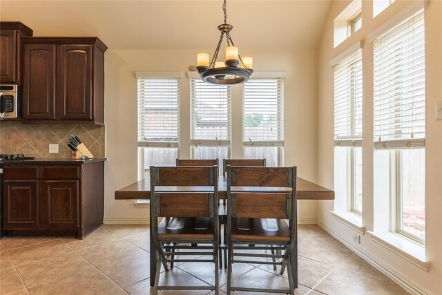 dining room featuring a notable chandelier, plenty of natural light, and light tile patterned floors