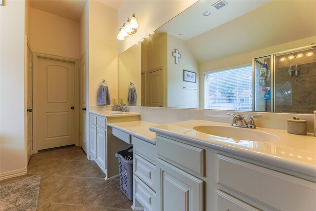 bathroom featuring a sink, double vanity, tile patterned floors, a shower stall, and visible vents