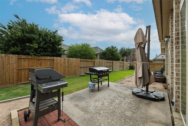 view of patio / terrace featuring a fenced backyard and a grill