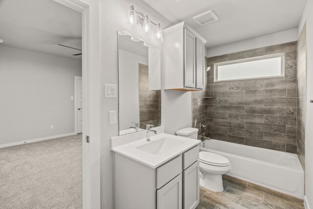 full bath with visible vents, washtub / shower combination, toilet, and vanity