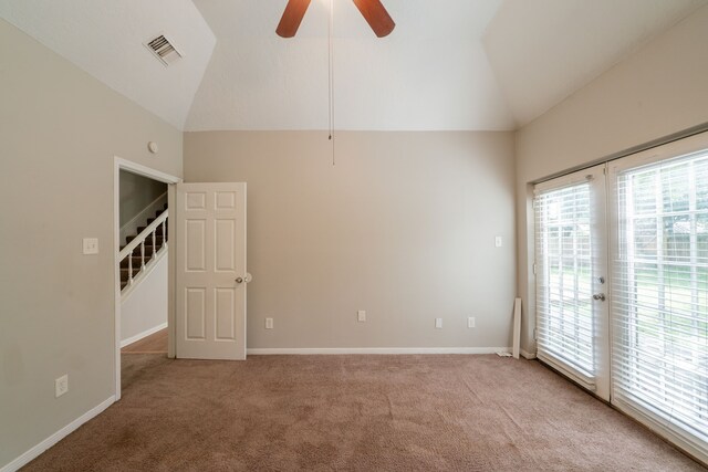 spare room with a ceiling fan, visible vents, plenty of natural light, and light carpet