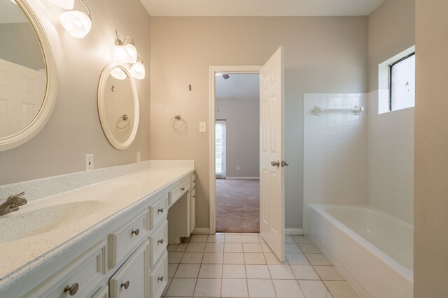 bathroom with tile patterned flooring, baseboards, and vanity