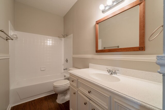 full bathroom featuring vanity, wood finished floors, bathtub / shower combination, and toilet
