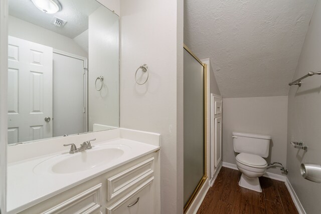 full bathroom with baseboards, a stall shower, a textured ceiling, and wood finished floors