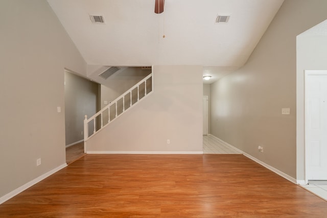 18927 Sandia Pines Dr, Humble, TX 77346 - unfurnished living room with lofted ceiling, ceiling fan, stairs, light wood-style flooring, and baseboards