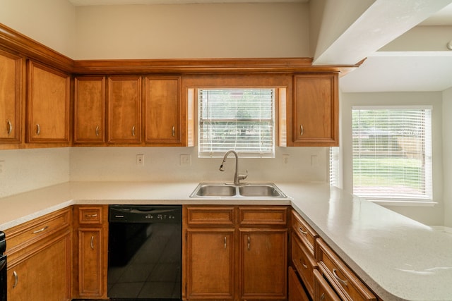 18927 Sandia Pines Dr, Humble, TX 77346 - kitchen with black dishwasher, a sink, light countertops, and brown cabinets