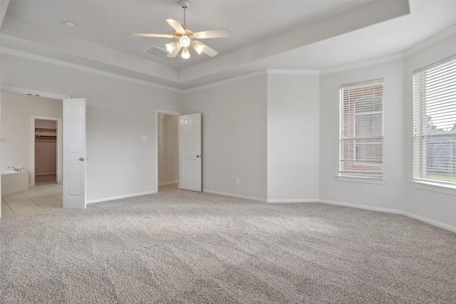 2126 Fortuna Bella Dr, Pearland, TX 77581 - unfurnished bedroom featuring light colored carpet, baseboards, a tray ceiling, and multiple windows