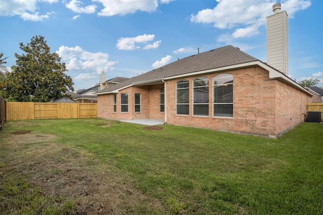 2126 Fortuna Bella Dr, Pearland, TX 77581 - back of house with a fenced backyard, central AC unit, a chimney, and brick siding