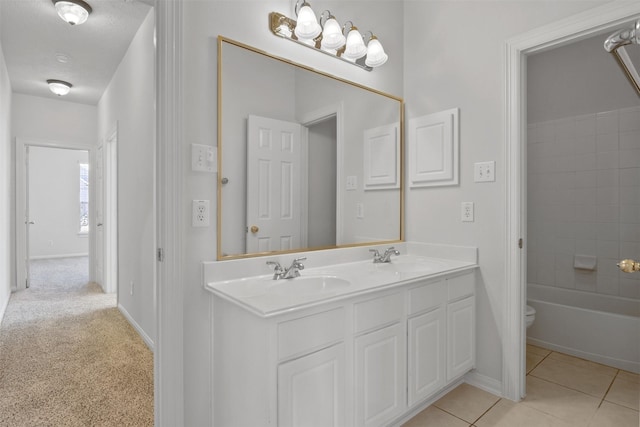 2126 Fortuna Bella Dr, Pearland, TX 77581 - full bathroom with double vanity, baseboards, toilet, and a sink