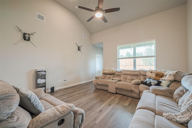 living room featuring a ceiling fan, visible vents, wood finished floors, high vaulted ceiling, and baseboards