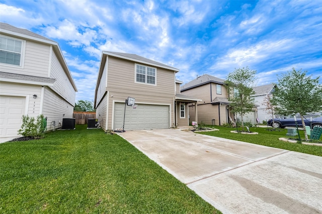 traditional-style home with central air condition unit, an attached garage, driveway, and a front lawn